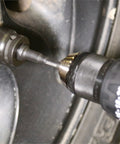 Close-up of Beefy Five Piece Impact Driver Bit Set With Hex Socket Adapters And Six Inch Drill Extension in action on a wheel