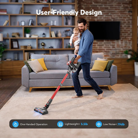 Cordless stick vacuum cleaner, front view, red, in use on living room carpet.