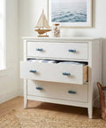 White dresser with Sperm Whale Shaped Cabinet Knobs 4 Piece Set In Vintage Ocean Blue Zinc Alloy for drawers.