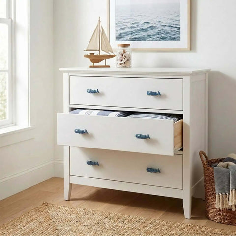White dresser with Sperm Whale Shaped Cabinet Knobs 4 Piece Set In Vintage Ocean Blue Zinc Alloy for drawers.