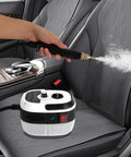 Powerful 2500W Handheld Steam Cleaner With 6 Adjustable Levels And 1L Water Tank used on car seat for deep cleaning