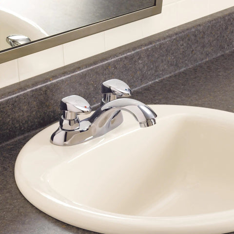 Two Handle Metering Commercial Bathroom Faucet With Chrome Finish And Vandal Resistant Color Coded Lever Handles in a sink.