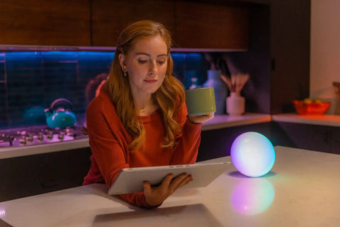 Smart Led Entertainment Lamp And Night Light With 16 Million Colors And Color Shifting Scenes on kitchen counter with woman
