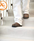 Person walking on stairs covered with Stay Put Canvas Plus Drop Cloth 6 Ft By 8 Ft Ultra Slip Resistant Backing Leak Resistant