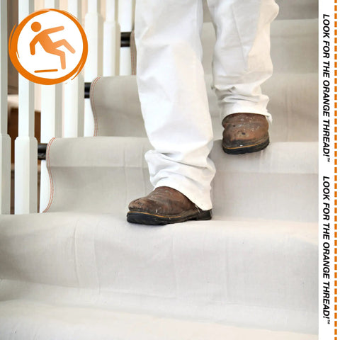 Person walking on stairs covered by Stay Put Canvas Plus Drop Cloth 9 Ft By 12 Ft With Leak Resistant Protection, Slip Resistant Backing
