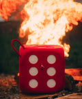 High Roller Foam Archery Target Cube With 21 Bullseyes, 13 Inch by 13 Inch, in front of flames, showing six-sided design
