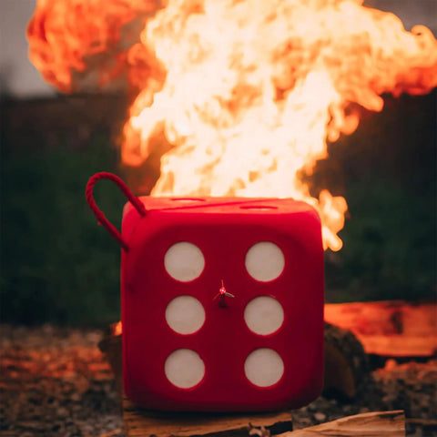 High Roller Foam Archery Target Cube With 21 Bullseyes, 13 Inch by 13 Inch, in front of flames, showing six-sided design