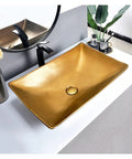 Next Level Golden Ceramic Vessel Sink For Above Counter Bathroom Vanity, sleek rectangular gold basin on vanity with black faucet.