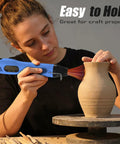 Person using Dual Temp Heat Gun With Two Speed Settings 250C And 350C 482F And 662F Fast Heat for crafting pottery.
