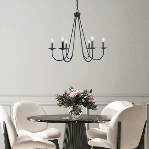 Black Six Light Farmhouse Chandelier With Candle Style Bulbs For Dining Room Bedroom And Living Room 28 Inch Wide And 24 And A Half Inch High Open Frame Iron Arms For A Dope Modern Rustic Look hanging above a dining table.