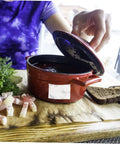 Person opening a red ceramic pot on a wooden board with herbs and bread, Heavy Duty High Temperature Leak Stop Tape For Home Plumbers Multi Purpose Seal Strip Ideal For Radiators Pots Buckets Aluminum Repair Oilproof And Tear Resistant Waterproof Water Leak Sealing Tape.