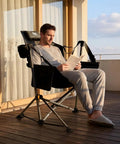 Man relaxing on Heavy Duty Folding Hammock Chair With Adjustable Backrest For Camping, Travel, And Patio, Supports Up To 300 Lbs, Padded Seat