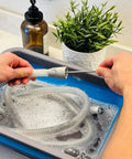 Hands using Hose And Mask Cleaning Kit With Extra Thick 6.9 Foot Tubing Brush in collapsible wash basin with CPAP hose