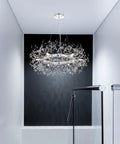 Modern Crystal Firework Chandelier Pendant Light In Chrome Silver Finish Round Hanging Fixture illuminating a stairwell.