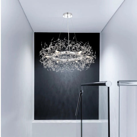 Modern Crystal Firework Chandelier Pendant Light In Chrome Silver Finish Round Hanging Fixture illuminating a stairwell.