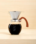 Next Level Pour Over Coffee Maker With Heat Resistant Borosilicate Glass Carafe And Comfortable Bamboo Handle Plus Durable Stainless Steel Filter, showcasing brewed coffee.