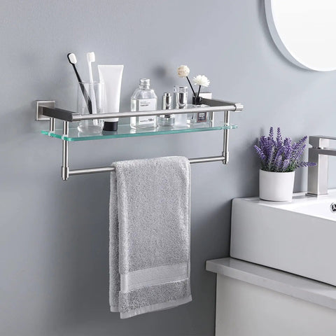 Bathroom Glass Shelf With Towel Bar And Rail 19.6 X 5.9 Inches Heavy Duty Rustproof SUS304 Stainless Steel Brushed Finish Wall Mount Shelf 8mm Tempered Glass holding toiletries and lavender next to a sink.