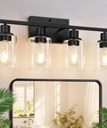 Sleek Matte Black Four Light Bathroom Vanity Wall Lamp With Thick Clear Glass Shades For Mirror Or Porch view from front with glowing bulbs.