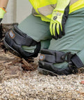 All Day Comfort Hinged Gel Knee Pads with slip resistant rubber caps and adjustable straps in use on rugged worksite