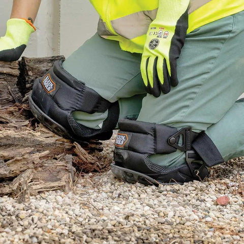 All Day Comfort Hinged Gel Knee Pads with slip resistant rubber caps and adjustable straps in use on rugged worksite