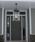 Large Twenty Five Inch Outdoor Pendant Light With Clear Glass And Sturdy Metal Build hanging at an entryway door.