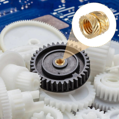 Close-up of a brass knurled twill nut installed on a black gear, highlighting the 100 Pack M5 Heat Set Threaded Inserts For 3D Printing.