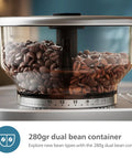 Semi Automatic Espresso Machine With Drip Free Barista Creations 58 Millimeter Portafilter dual bean holder filled with coffee beans.