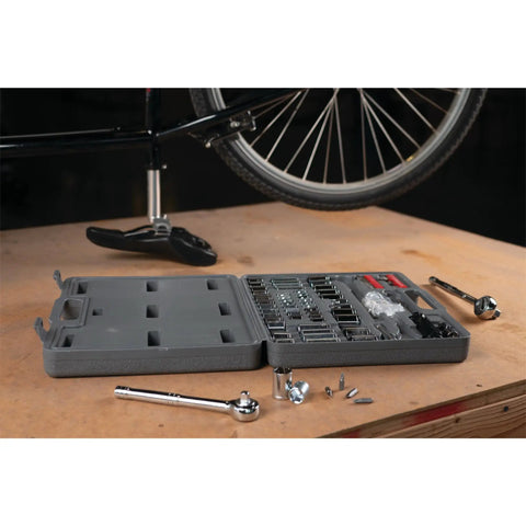 SAE And Metric 100 Piece Socket Set With One Quarter Inch Drive Three Eighths Inch Drive And One Half Inch Drive Plus Bit Set on workbench