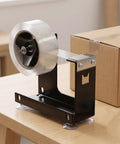 Heavy Duty Desktop Tape Dispenser With Solid Steel Base And Precision Serrated Blade For Straight Up Clean Cuts On Packing Boxes And Office Supplies No Sweat Desk Setup on wooden desk.