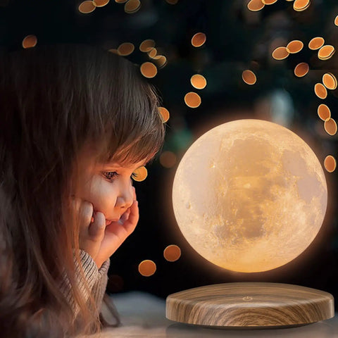Child gazing at Magnetic Levitation Floating Moon Lamp With Base 360 Spin 3D Printed Moon Night Light in warm LED glow