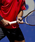 Man playing tennis wearing copper infused compression wrist sleeve for men and women boost circulation and recovery.