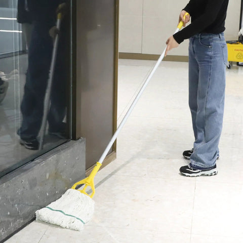 Person using a mop near a window with a 35 Quart Commercial Mop Bucket With Side Press Wringer On Wheels Included Industrial Mop Yellow For Heavy Duty Floor Cleaning And Mopping With Durable 50K Cycles Wringer And Rectangular Design in the background.