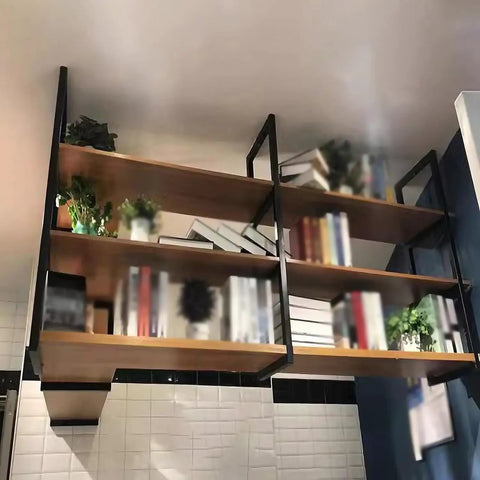 Industrial Wrought Iron Three Tier Floating Shelf Brackets Built Like A Tank For Ceiling And Wall Mount showcasing books and plants.