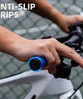 Close-up of hand holding blue Double Lock On Bike Handlebar Grips Non Slip Grippy Comfort Rubber Grips on bicycle handlebar.