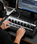Person using HA800S Eight Channel Stereo Line Mixer for sub-mixing with independent control in studio setting