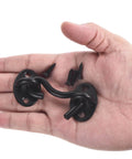 Two Pack 2 Inch Hook And Eye Latch For Privacy Stainless Steel Barn Door Lock Hardware in black finish, shown on hand