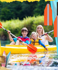 Family kayaking in calm waters with safety gear and paddles