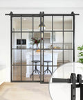 Bypass Double Glass Barn Door Kit With 84 By 84 In Clear Tempered Glass And 7.5 Ft Side Mounted Aluminum Black Frame in living room