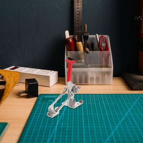 Heavy Duty Adjustable Toggle Latch Clamp for Sliding Doors and Storage Boxes on a workbench with tools in background.