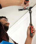 Man using an 18 Inch Indexing Flat Pry Bar With 15 Locking Positions Raised Striking Surface For Hammer Or Mallet Use Dual Material Grip