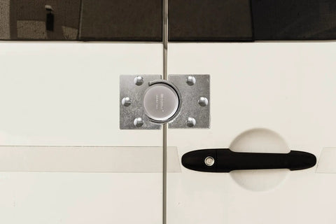 Commercial Puck Lock With Round Hasp, Solid Steel Body And Boron Steel Shackle, installed on white door panel