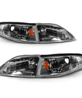 Pair of gun-metal replacement headlights with amber turn signals for 1994–1998 Ford Mustang, passenger and driver sides.
