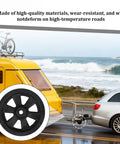 8-inch black trailer caster wheel with white tire, foreground; RV camper towing setup in background