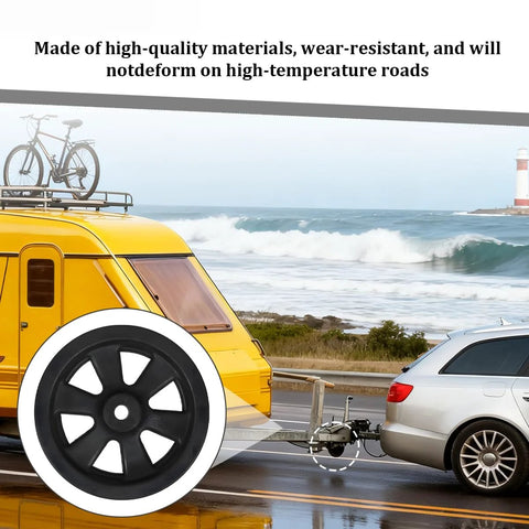 8-inch black trailer caster wheel with white tire, foreground; RV camper towing setup in background