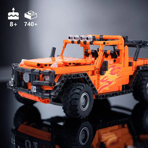 Remote And App Controlled Off Road Truck Building Kit With 740 Plus Pieces STEM Learning Toy, orange model on reflective surface.
