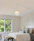 Straight Up Gold Plug In Pendant Light With 16 Foot Long Cord And Sparkling Three Tier Crystals For Kitchen Island Or Cozy Bedroom Setup Premium Slick Mini Chandelier Drip hanging above a bed in a cozy room.
