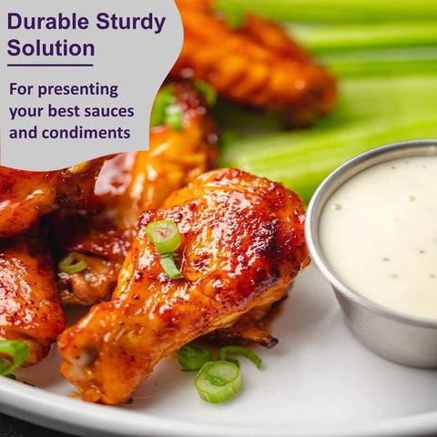 Stainless Steel Sauce Cups Set 12-Pack Small Dipping Ramekins for Condiments next to chicken wings and celery sticks on a plate