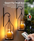 Person using remote with Six Pack Remote Timer Flameless Candles 2x2 LED Votive Lights Battery Operated in wall sconces.