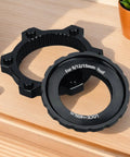 Center Lock Adapter For Bikes Lightweight Aluminum Disc Brake Rotor Upgrade displayed on wooden surface