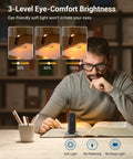 Man reading with Amber Glow Clip On Book Light With 1800K Eye Care LED, showing 3-level brightness, in a dimly lit library.